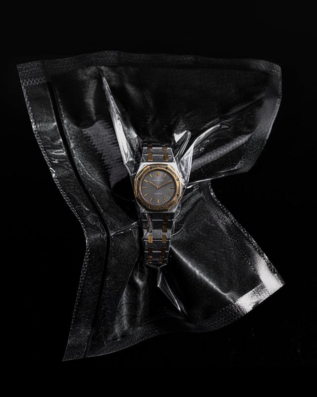Watch in a crumpled plastic sleeve, Dimepiece by David Spector